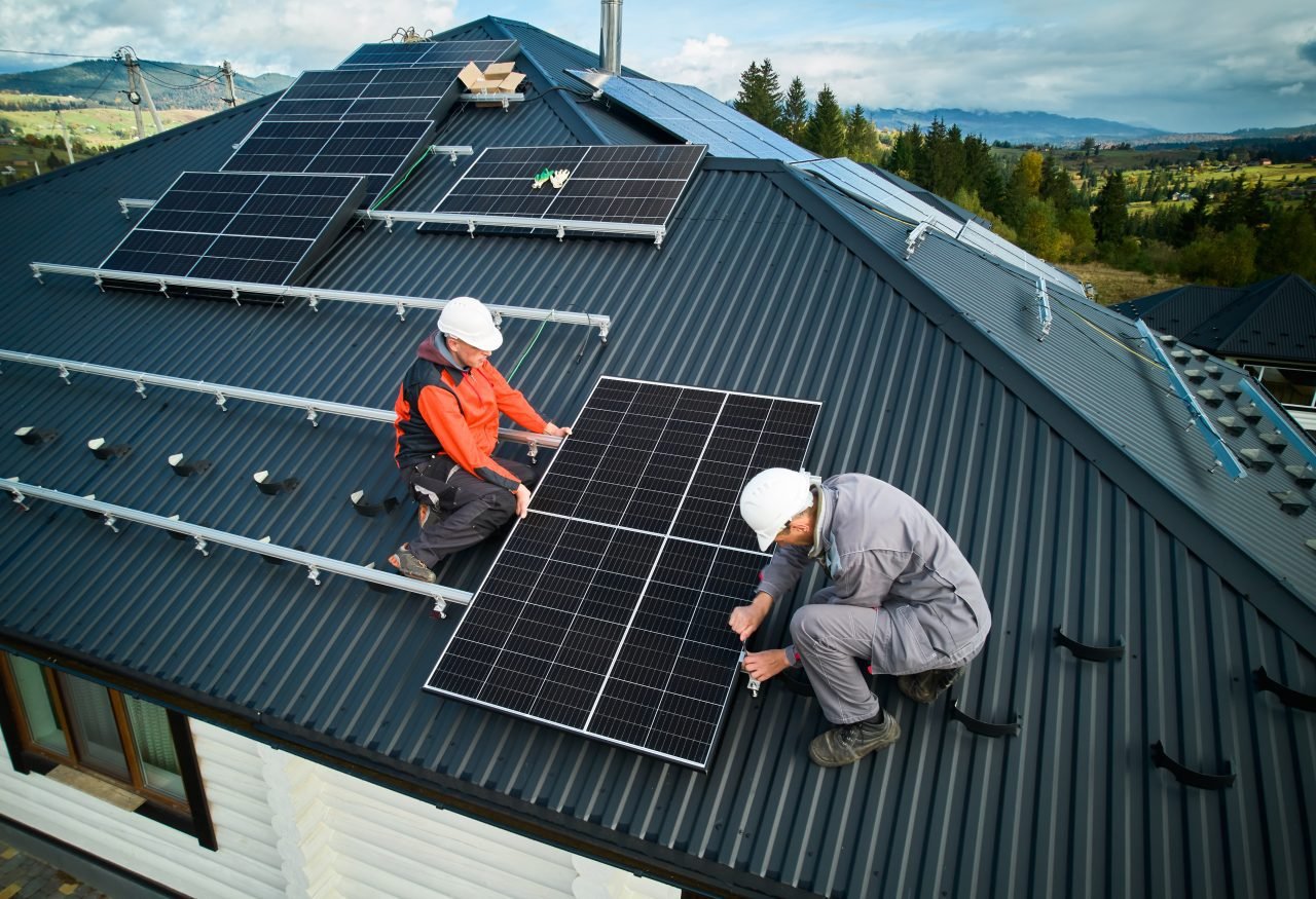 technicians-installing-photovoltaic-solar-panels-on-roof-of-house.jpg